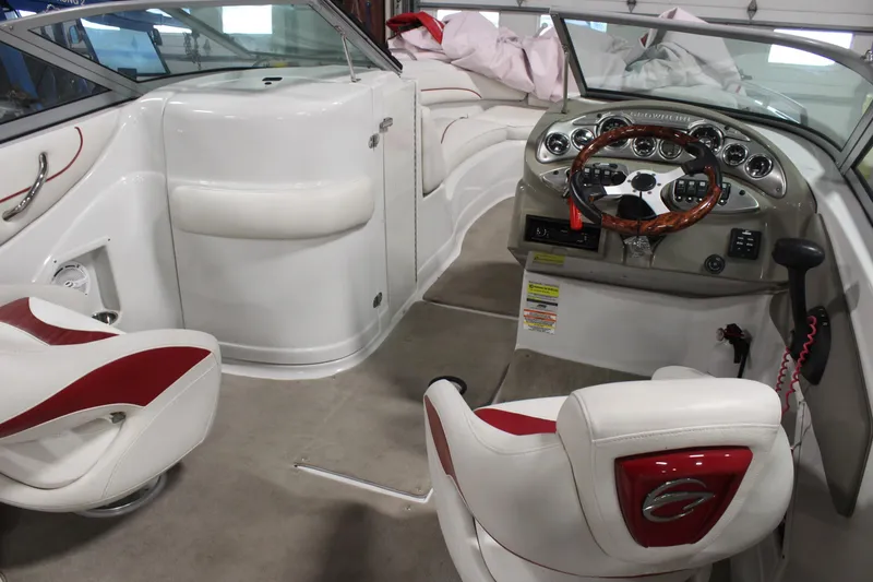 Slide: The Image of 2008 Crownline 220 EX boat interior with white and red seating, modern dashboard, and steering wheel. - 12