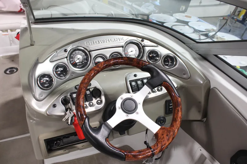 Slide: The Image of Dashboard of a 2008 Crownline 220 EX boat with wood-accented steering wheel. - 15