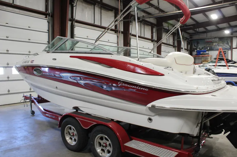 Slide: The Image of 2008 Crownline 220 EX boat on trailer in indoor storage facility. - 2