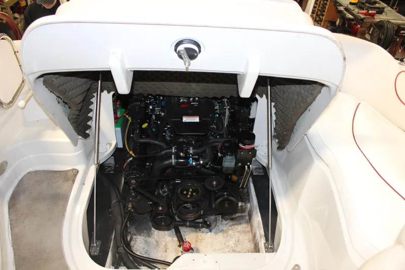 Slide: The Image of Open engine compartment of a 2008 Crownline 220 EX boat, showcasing internal components. - 24