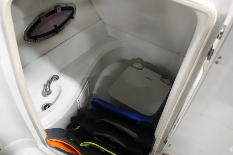 Slide: The Image of 2008 Crownline 220 EX boat interior with sink, portable toilet, and life jackets. - 25