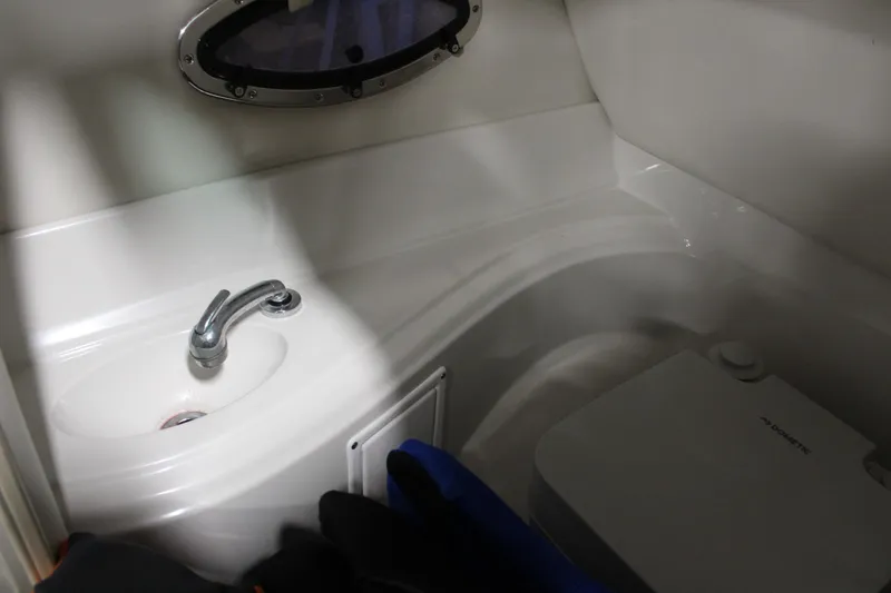 Slide: The Image of 2008 Crownline 220 EX boat interior with sink and compact toilet. - 26