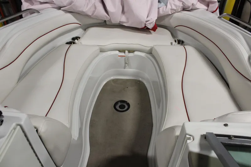 Slide: The Image of 2008 Crownline 220 EX boat interior with white seating and red accents. - 27