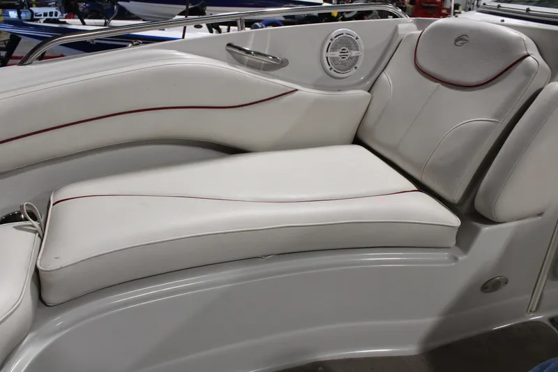 Slide: The Image of 2008 Crownline 220 EX boat interior with white cushioned seating and speaker. - 29