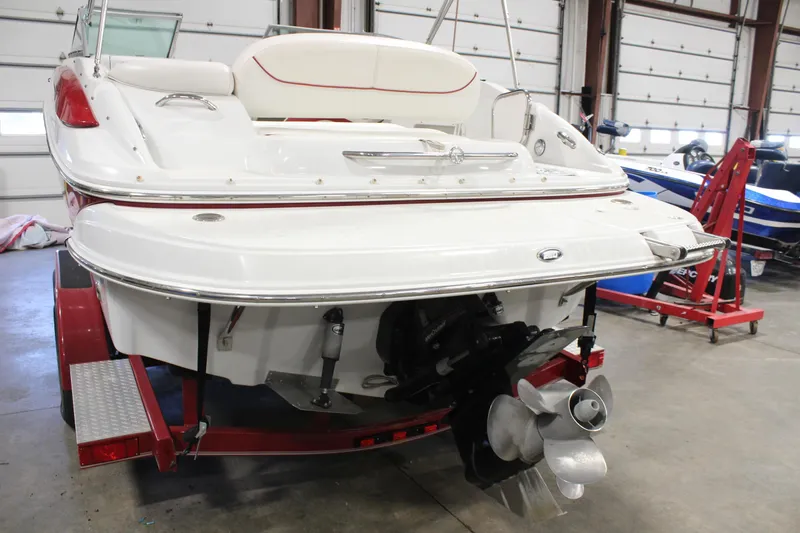 Slide: The Image of 2008 Crownline 220 EX boat on trailer in garage, rear view. - 3