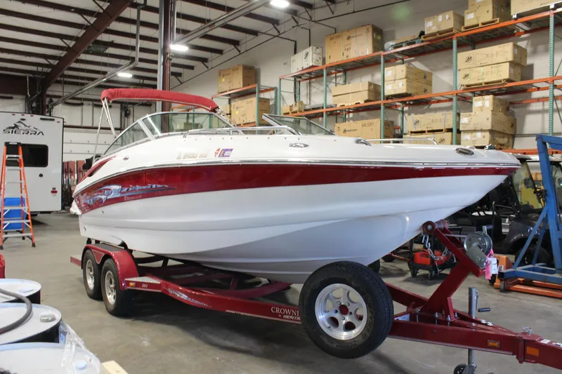 Slide: The Image of 2008 Crownline 220 EX boat on trailer in warehouse setting. - 6