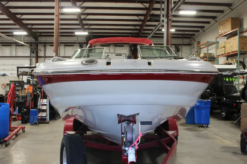 Slide: The Image of 2008 Crownline 220 EX boat on trailer in a warehouse setting. - 7