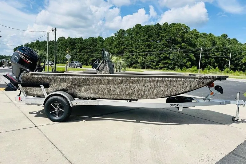 The Image of 2026 Thor 1900 boat on trailer, parked outdoors under a clear sky. - 0