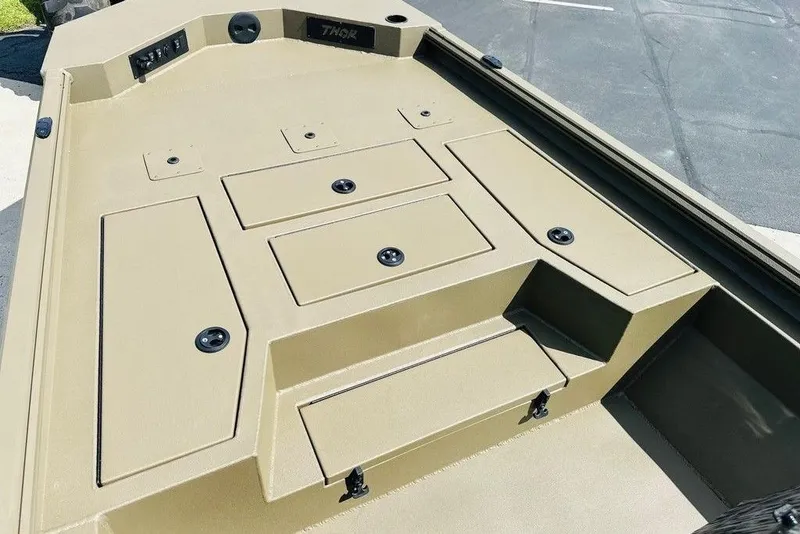 Slide: The Image of 2026 Thor 1900 boat deck with storage compartments and sleek design. - 7