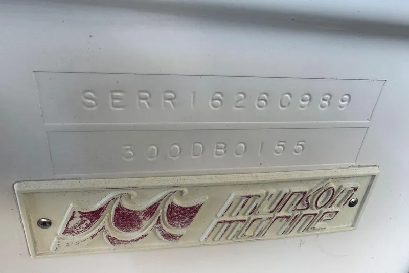 Slide: The Image of 1989 Sea Ray 300 Sedan Bridge hull identification and emblem, featuring "Munson Marine." - 10