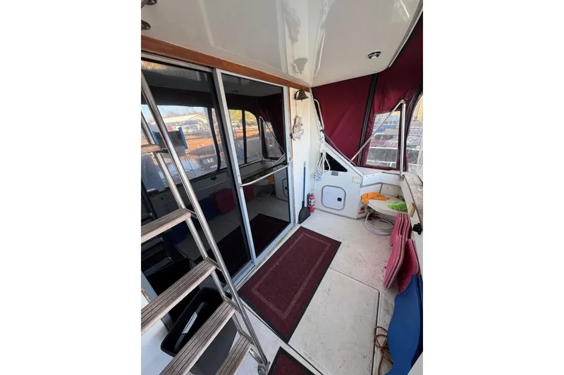 Slide: The Image of 1989 Sea Ray 300 Sedan Bridge interior with maroon accents and ladder. - 11
