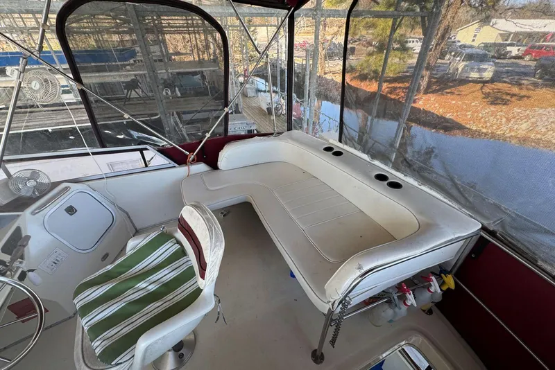 Slide: The Image of 1989 Sea Ray 300 Sedan Bridge interior with seating and helm, featuring striped chair. - 12