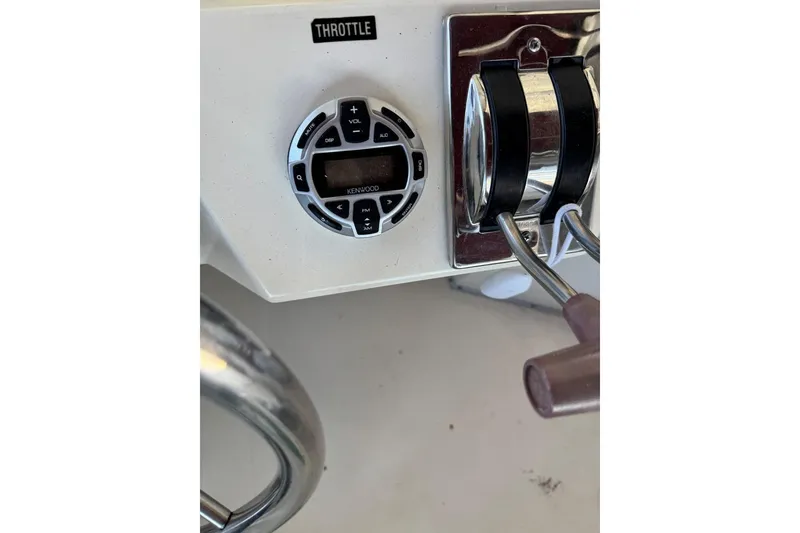Slide: The Image of Throttle controls and Kenwood audio system on 1989 Sea Ray 300 Sedan Bridge. - 17