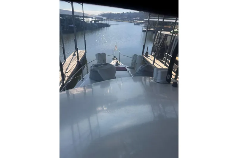 Slide: The Image of 1989 Sea Ray 300 Sedan Bridge docked at marina, calm water view. - 18