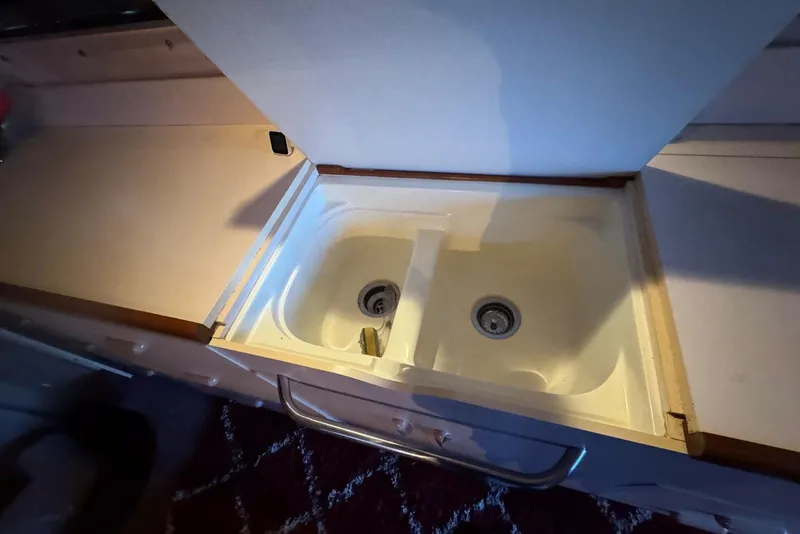 Slide: The Image of Kitchen sink in 1989 Sea Ray 300 Sedan Bridge boat interior, featuring dual basins. - 23