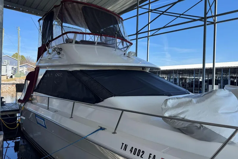Slide: The Image of 1989 Sea Ray 300 Sedan Bridge docked in a covered marina. - 3