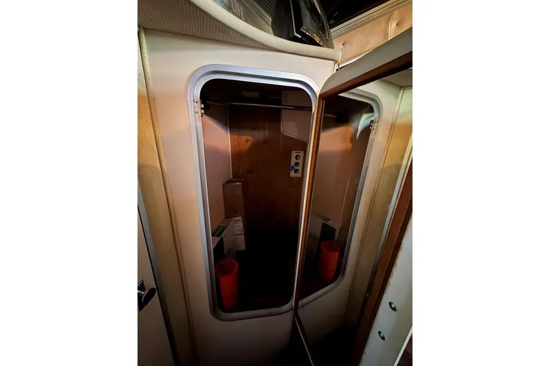Slide: The Image of Interior view of 1989 Sea Ray 300 Sedan Bridge cabin closet. - 33