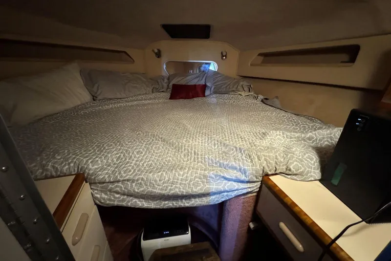 Slide: The Image of Cozy cabin interior of 1989 Sea Ray 300 Sedan Bridge with comfortable bedding. - 34