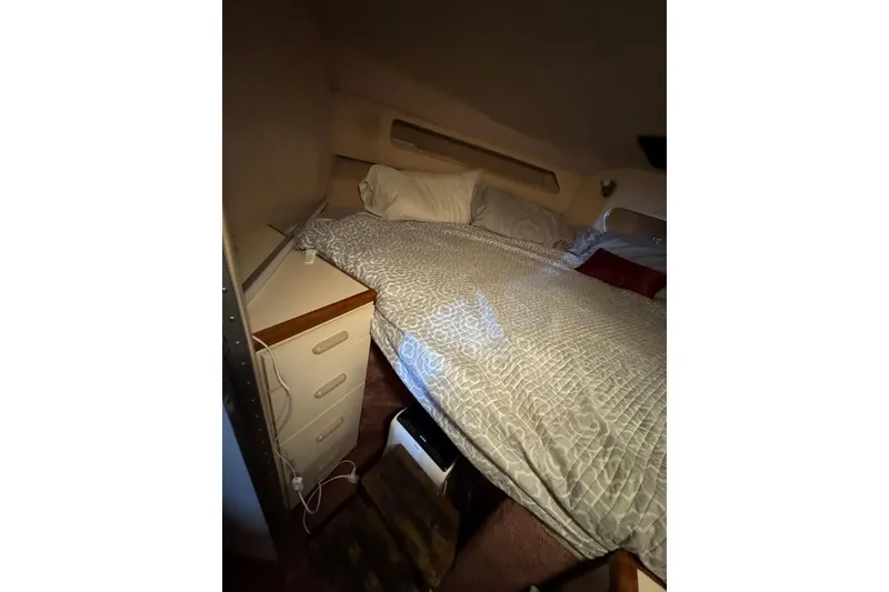 Slide: The Image of Cozy cabin interior of 1989 Sea Ray 300 Sedan Bridge with bed and storage. - 35