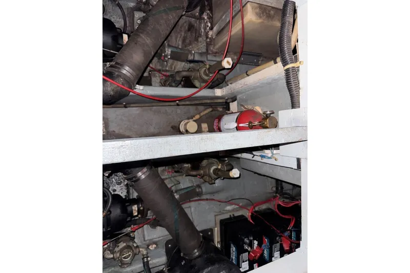 Slide: The Image of Engine compartment of 1989 Sea Ray 300 Sedan Bridge with fire extinguisher and wiring. - 40