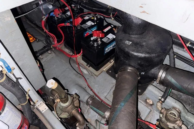 Slide: The Image of Engine compartment of 1989 Sea Ray 300 Sedan Bridge with batteries and wiring. - 41