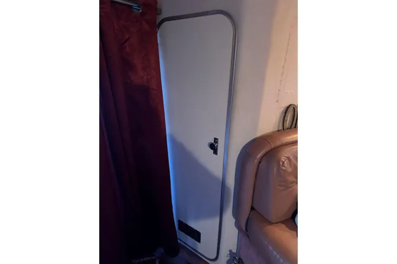 Slide: The Image of Interior cabin door of 1989 Sea Ray 300 Sedan Bridge boat. - 42