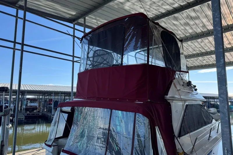Slide: The Image of 1989 Sea Ray 300 Sedan Bridge docked under a covered marina. - 6