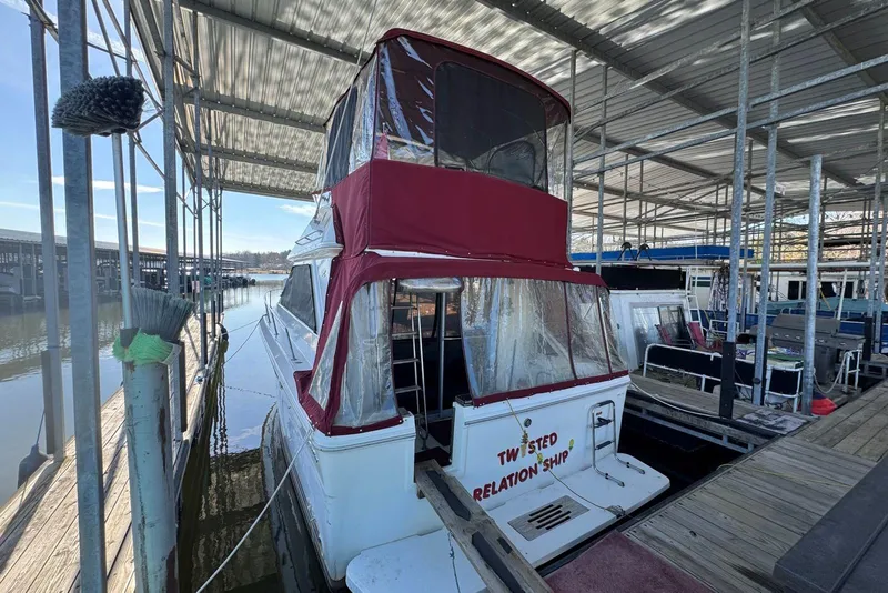 Slide: The Image of 1989 Sea Ray 300 Sedan Bridge docked under a covered marina. - 7