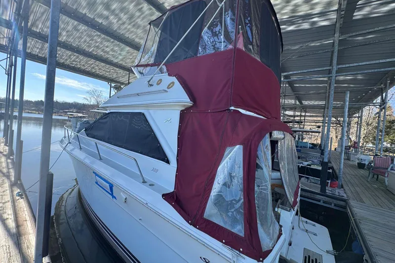 Slide: The Image of 1989 Sea Ray 300 Sedan Bridge docked under a covered marina. - 8