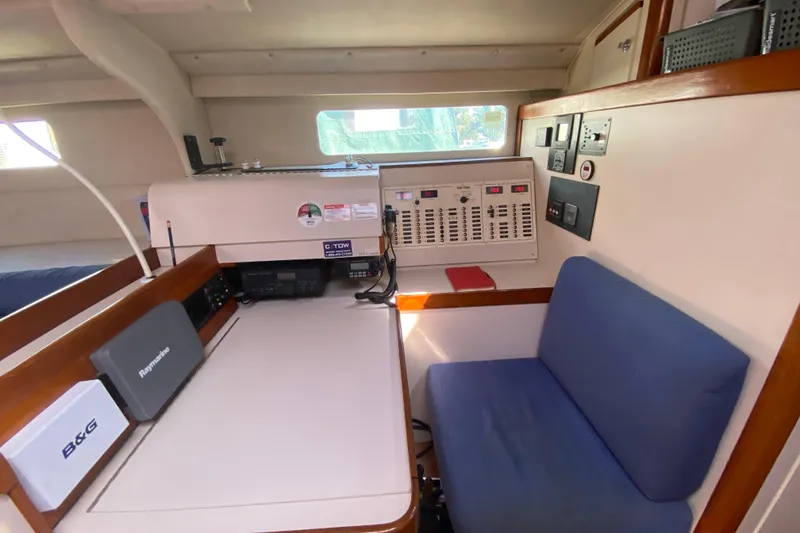 Slide: The Image of Navigation station inside a 1995 Sundeer 56 yacht, featuring control panels and seating. - 10