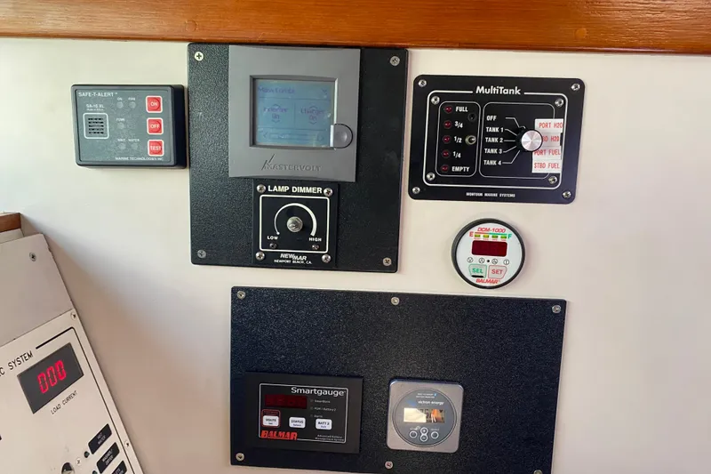 Slide: The Image of Control panel of a 1995 Sundeer 56 yacht with various gauges and switches. - 11