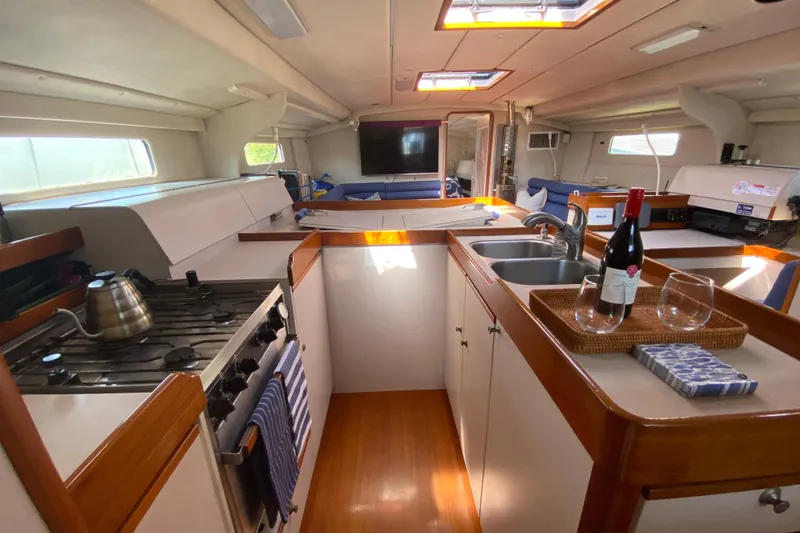 Slide: The Image of Spacious 1995 Sundeer 56 yacht interior with kitchen, wine, and modern amenities. - 15