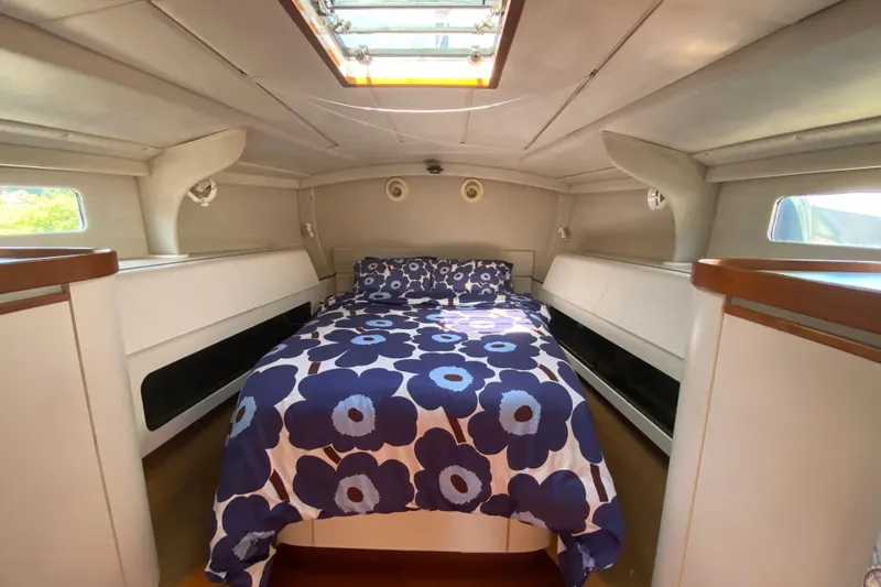 Slide: The Image of Interior of a 1995 Sundeer 56 yacht with floral bedding. - 18