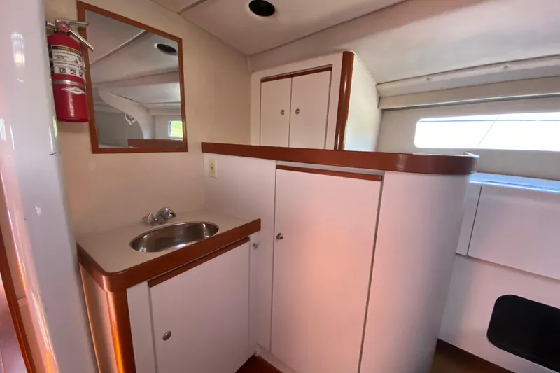 Slide: The Image of Compact bathroom area in a 1995 Sundeer 56 yacht with sink and storage. - 19