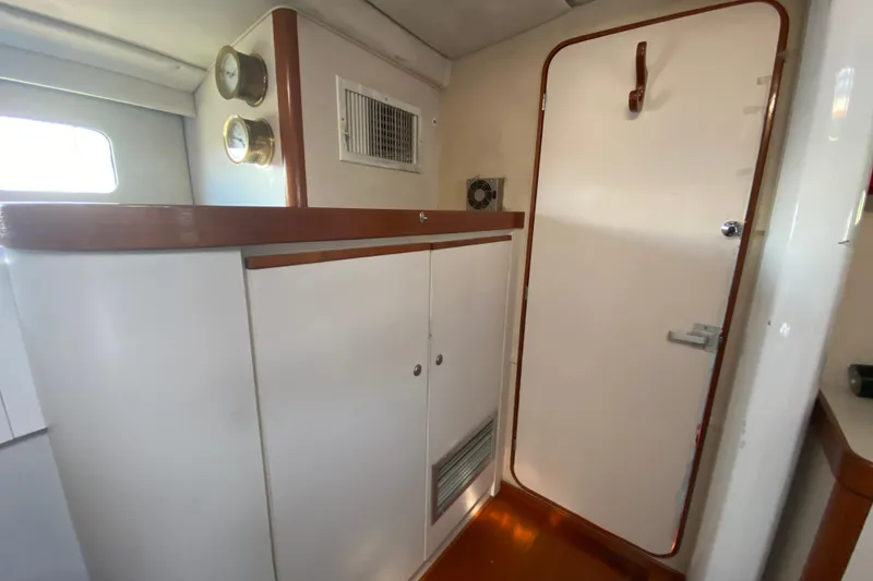 Slide: The Image of Interior of 1995 Sundeer 56 yacht with white cabinetry and wooden accents. - 20