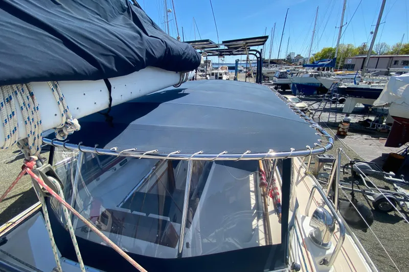 Slide: The Image of Sundeer 56 sailboat from 1995 with covered deck, docked in a marina. - 30