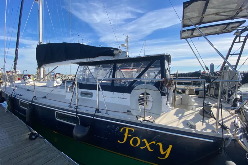 Slide: The Image of Sundeer 56 sailboat named "Foxy" docked at a marina, 1995 model. - 31