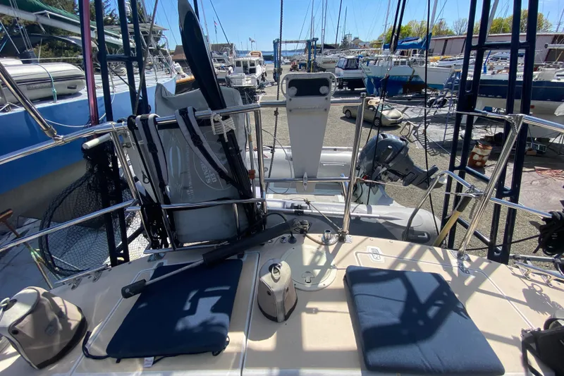 Slide: The Image of Sundeer 56 sailboat deck, 1995 model, in a marina with various equipment and boats. - 37
