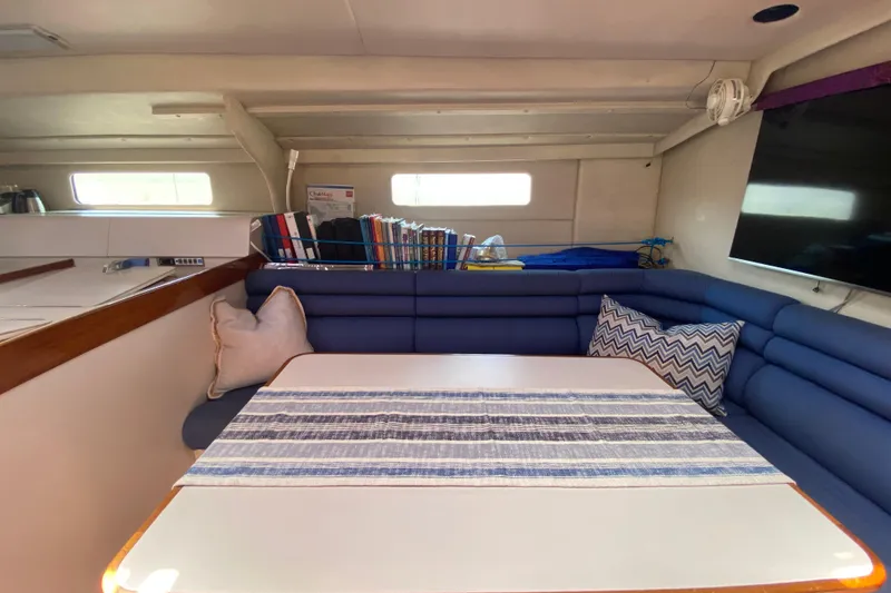 Slide: The Image of Cozy interior of 1995 Sundeer 56 yacht with blue seating and striped table runner. - 5