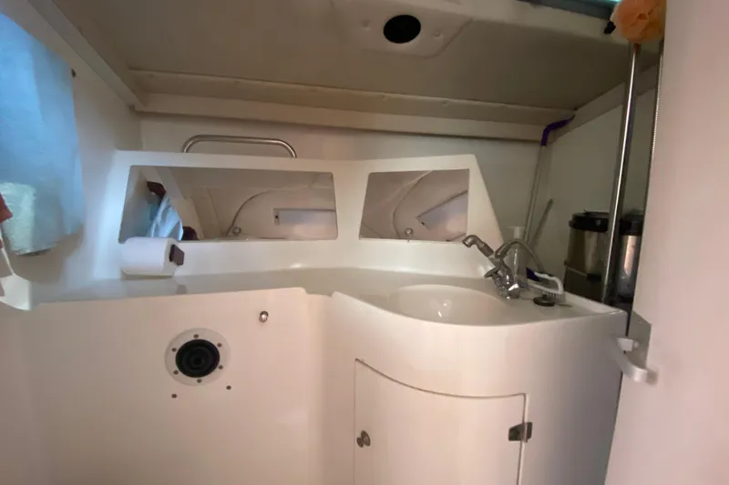 Slide: The Image of Compact bathroom in 1995 Sundeer 56 yacht with sink, mirror, and storage. - 6