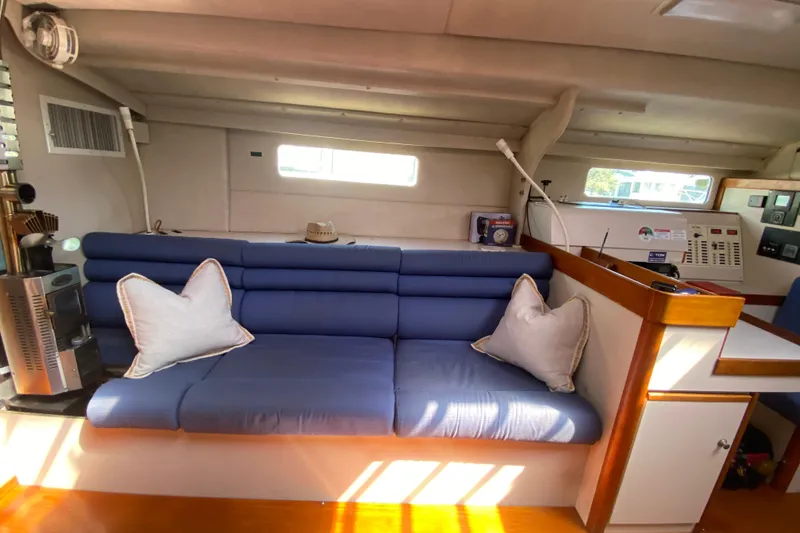 Slide: The Image of Cozy interior of a 1995 Sundeer 56 yacht with blue seating and white pillows. - 8