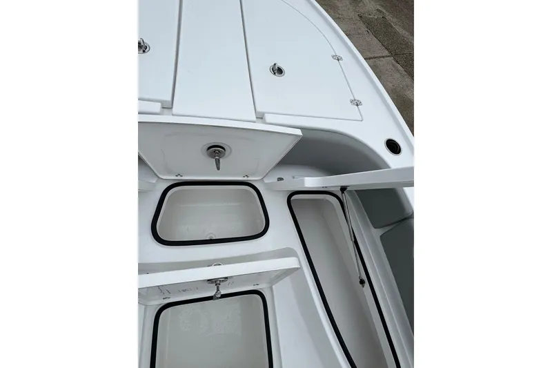 Slide: The Image of 2026 Blazer Bay 2440 boat interior with open storage compartments. - 11