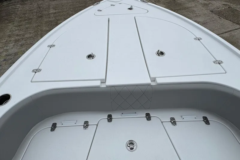 Slide: The Image of 2026 Blazer Bay 2440 boat deck with storage compartments and sleek design. - 12