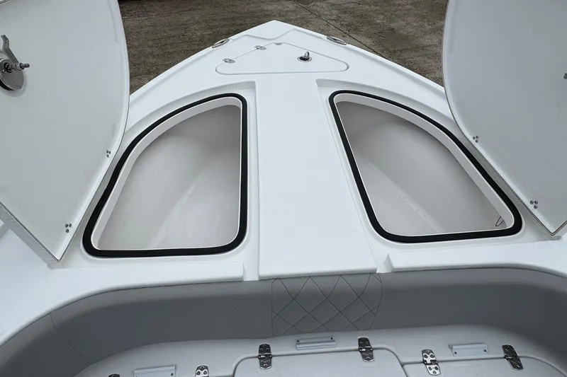 Slide: The Image of 2026 Blazer Bay 2440 boat with open storage compartments on deck. - 13