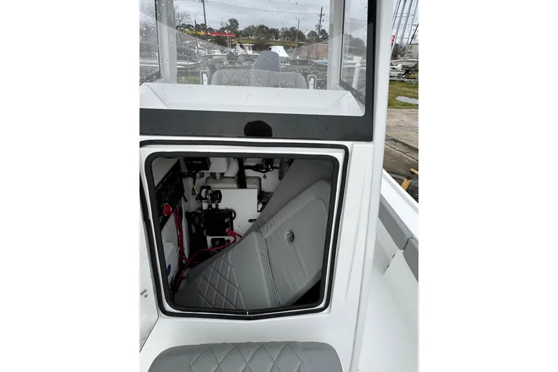 Slide: The Image of 2026 Blazer Bay 2440 boat interior with open storage compartment and visible wiring. - 17