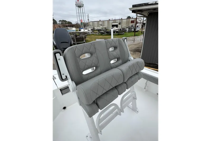 Slide: The Image of 2026 Blazer Bay 2440 boat with gray cushioned seating, outdoor setting. - 20