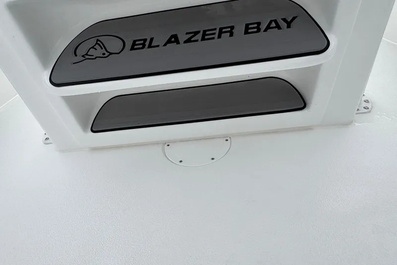 Slide: The Image of 2026 Blazer Bay 2440 boat detail with logo on white surface. - 22