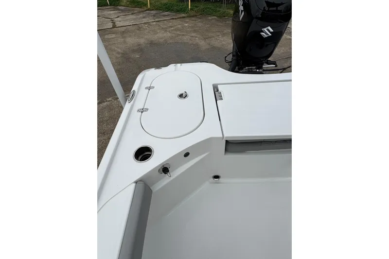 Slide: The Image of 2026 Blazer Bay 2440 boat deck with storage compartments and motor. - 26
