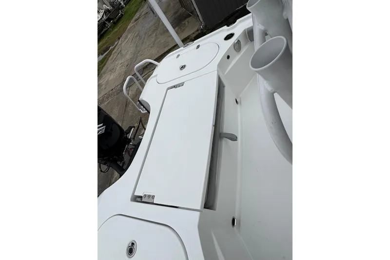 Slide: The Image of 2026 Blazer Bay 2440 boat deck with storage compartments and rod holders. - 28