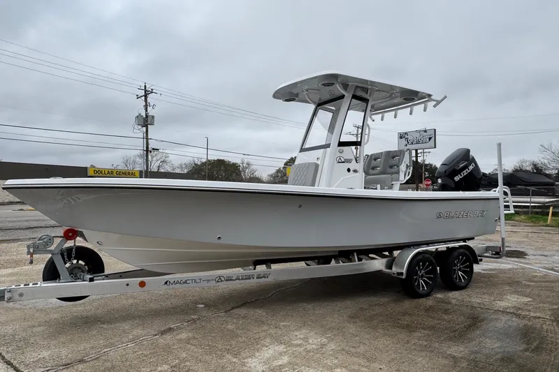 Slide: The Image of 2026 Blazer Bay 2440 boat on trailer, parked outdoors, overcast sky. - 3